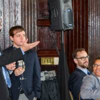 Attendee motions toward Marcia and President Haas